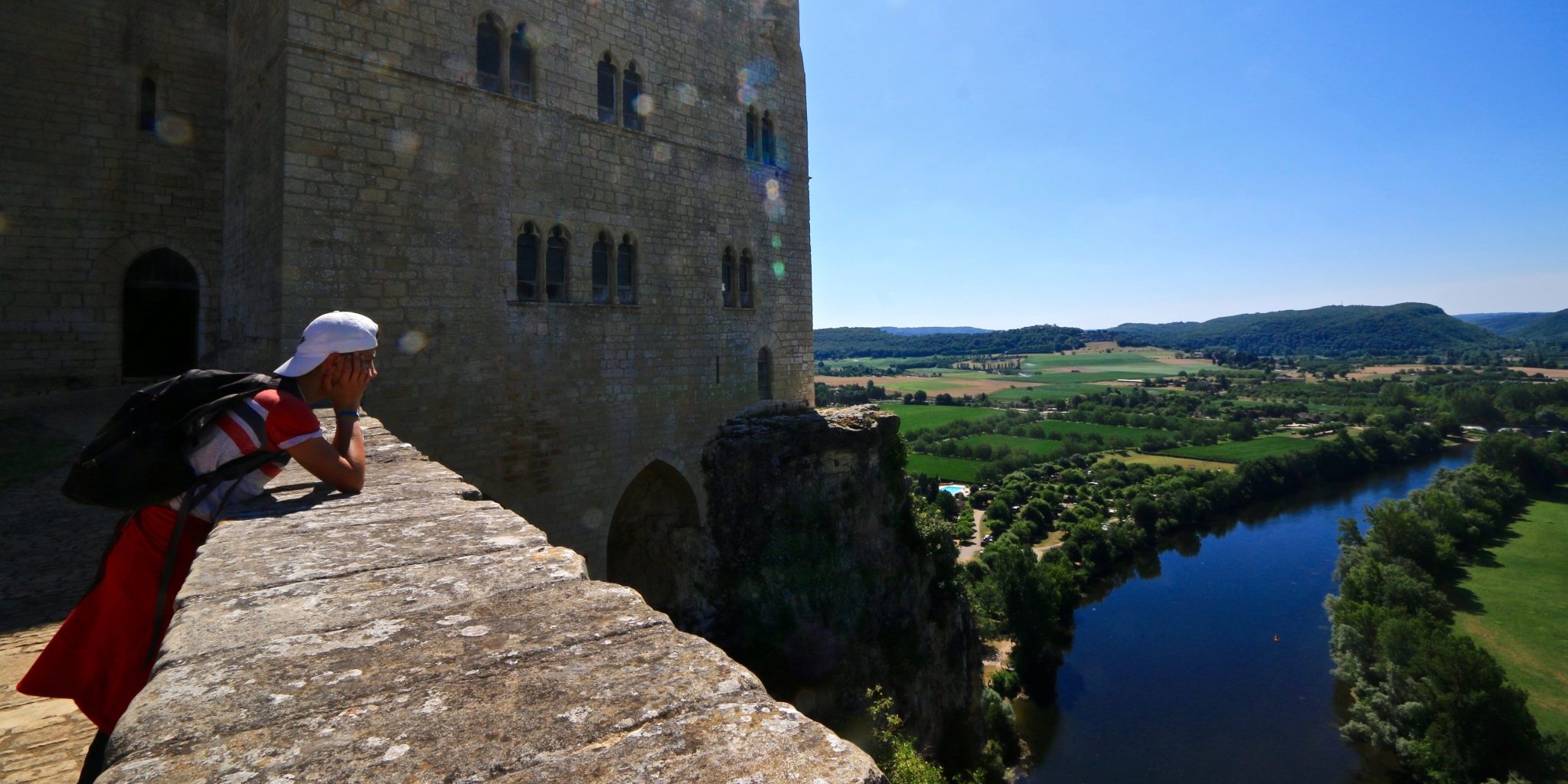 a teenager watching the view from a rampart in dordogne