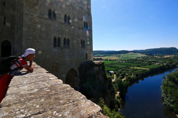 a teenager watching the view from a rampart in dordogne