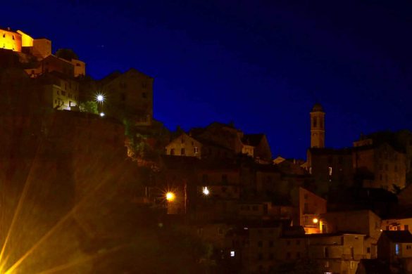 corte village illuminated at night