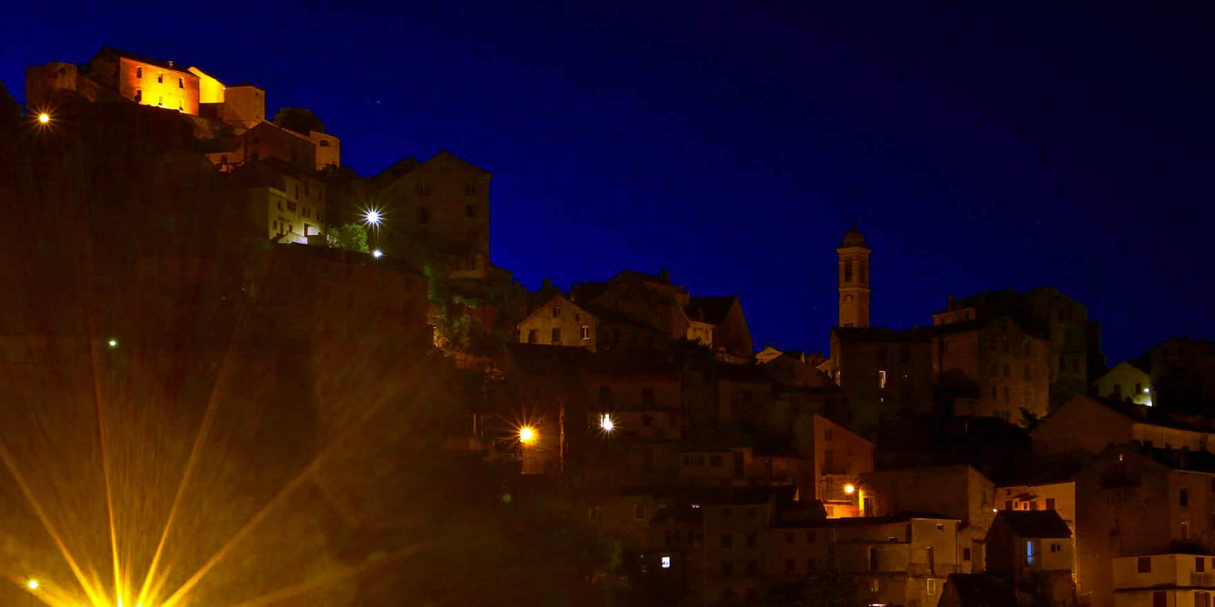 corte village illuminated at night