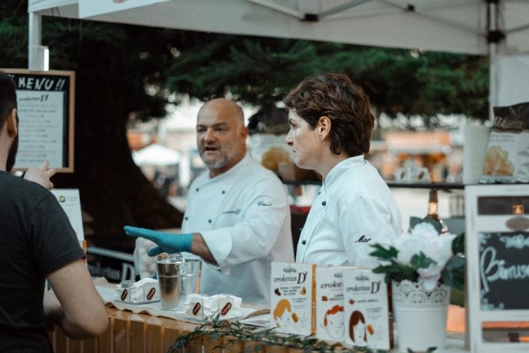 two local chefs showing off their products at a food festival