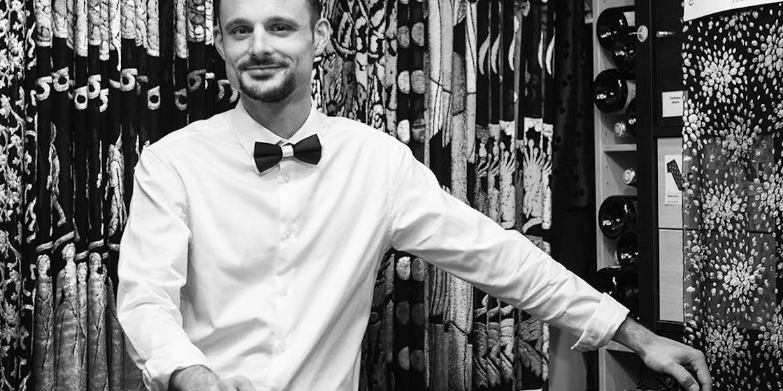 a black and white picture of a man with a bow tie