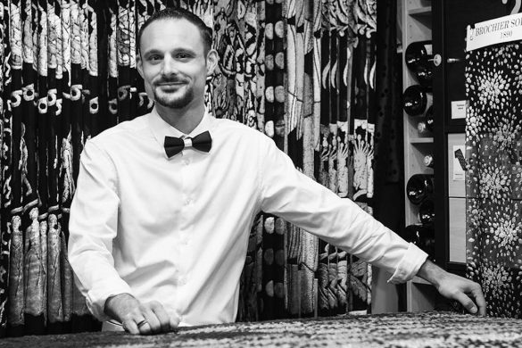 a black and white picture of a man with a bow tie