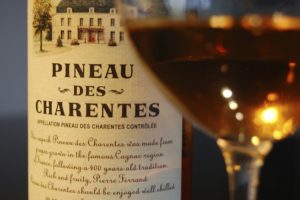 a bottle and glass of pineau des charentes
