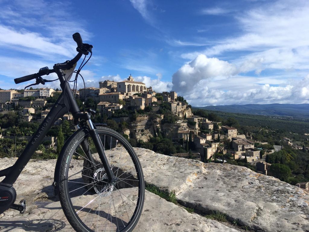 e-bike in front of a pittoresque village in provence