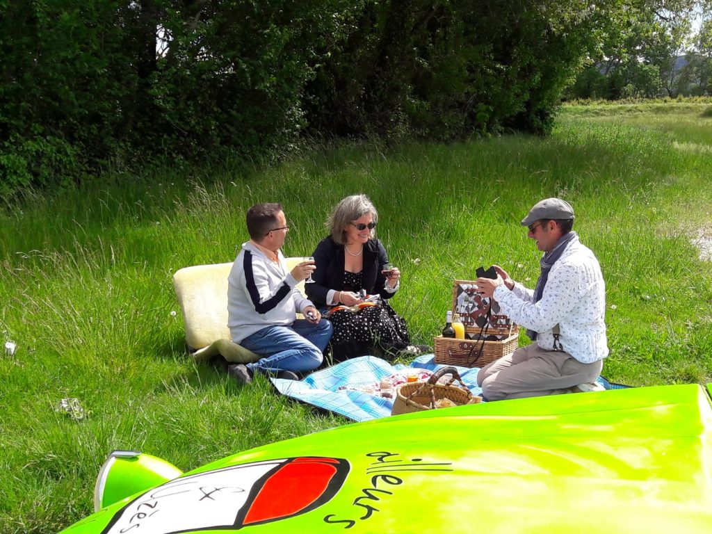 a group of three people talking while picnic uzes south of france