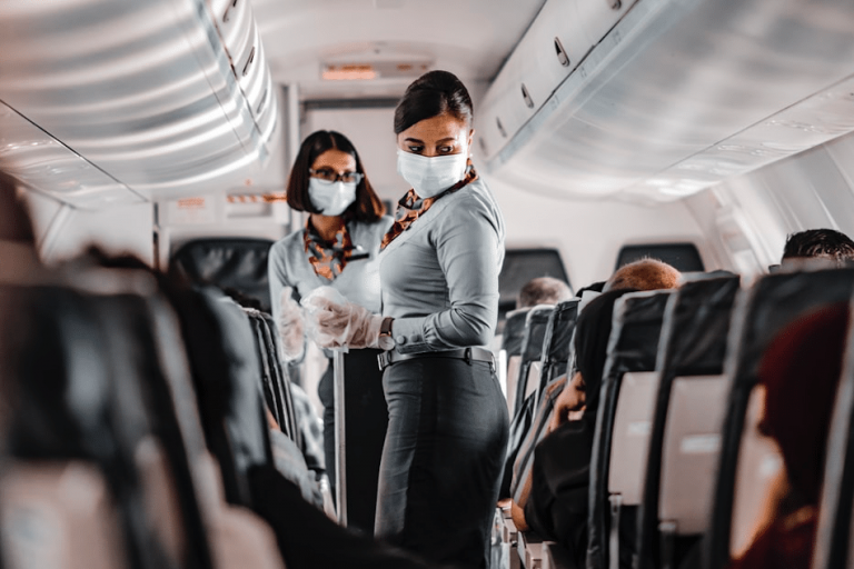 air hostess wearing mask in a plane IATA