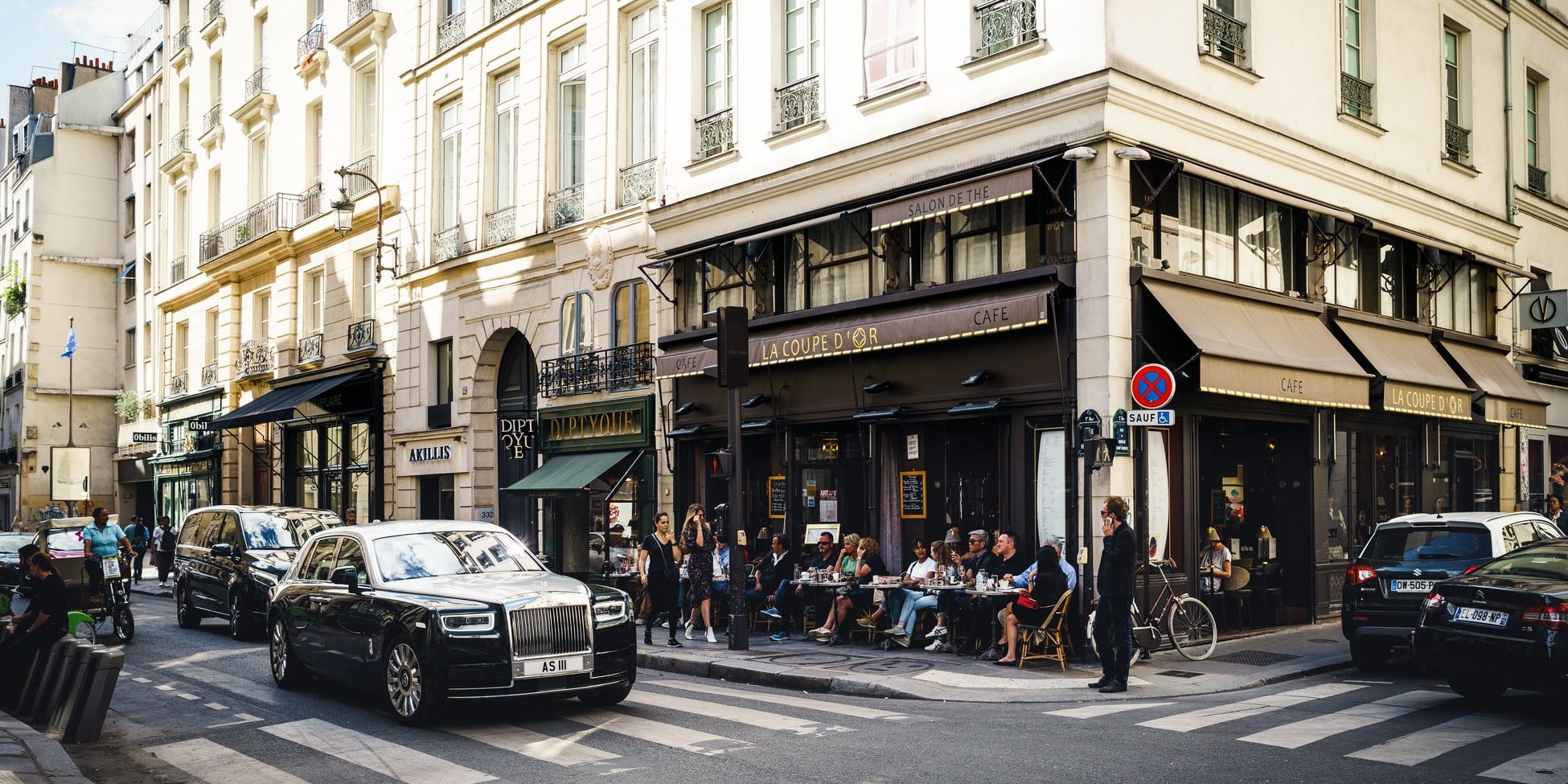 a street in paris with black cars