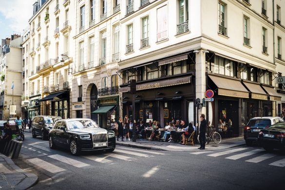 a street in paris with black cars