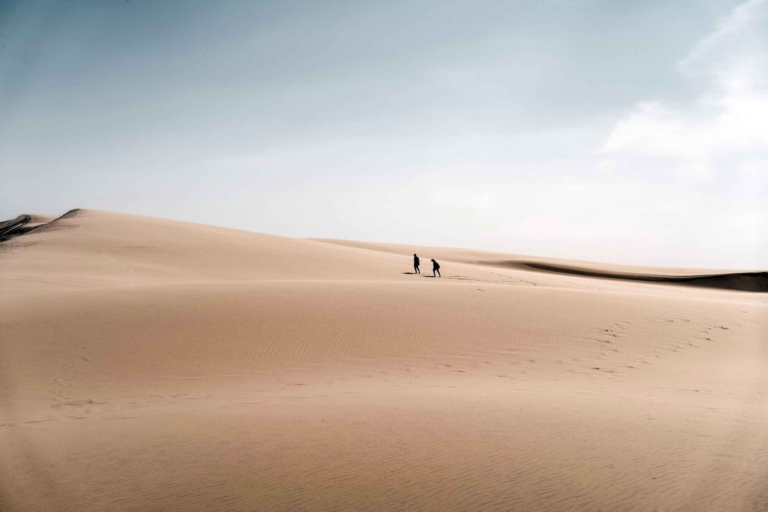 Two people crossing the Dune du Pilat seven wonders of france